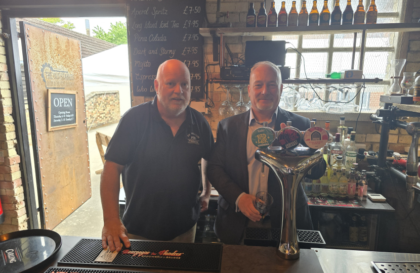 Richard Fuller MP pulling a pint at the Sir William Peel pub in Sandy