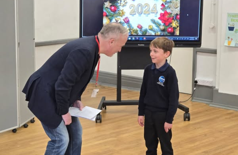 Richard with Christmas card competition winner Reggie Kidd at Harrold Primary