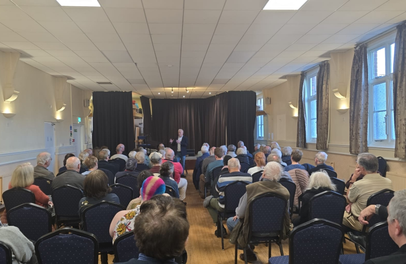 Richard addressing a town hall meeting in Sandy