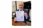 Richard holding the winning entry for his 2023 Christmas Card Competition 