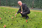 Richard 'planting' a Remembrance Stake in the parliamentary Garden of Remembrance