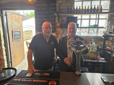 Richard Fuller MP pulling a pint at the Sir William Peel pub in Sandy