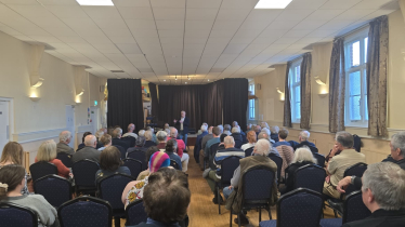 Richard addressing a town hall meeting in Sandy