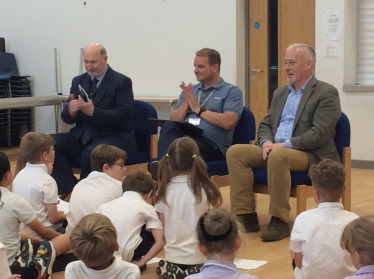 Headmaster Mr Leigh Pointon, Richard Fuller MP and Cllr Jim Weir listening to presentations from students at Riseley and Wilden Primary Schools