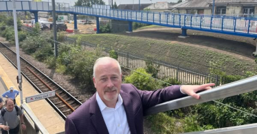 Richard Fuller MP at Biggleswade Railway station with new ramps in background
